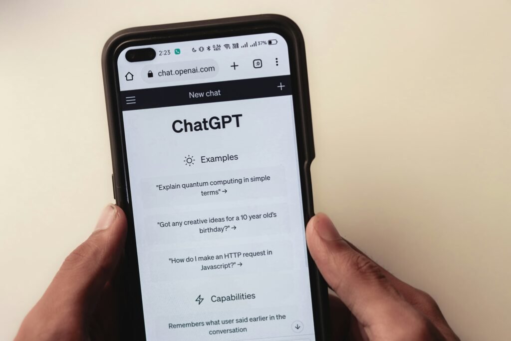 Hands holding smartphone displaying ChatGPT interface, representing how patients use AI chat to find med spa recommendations