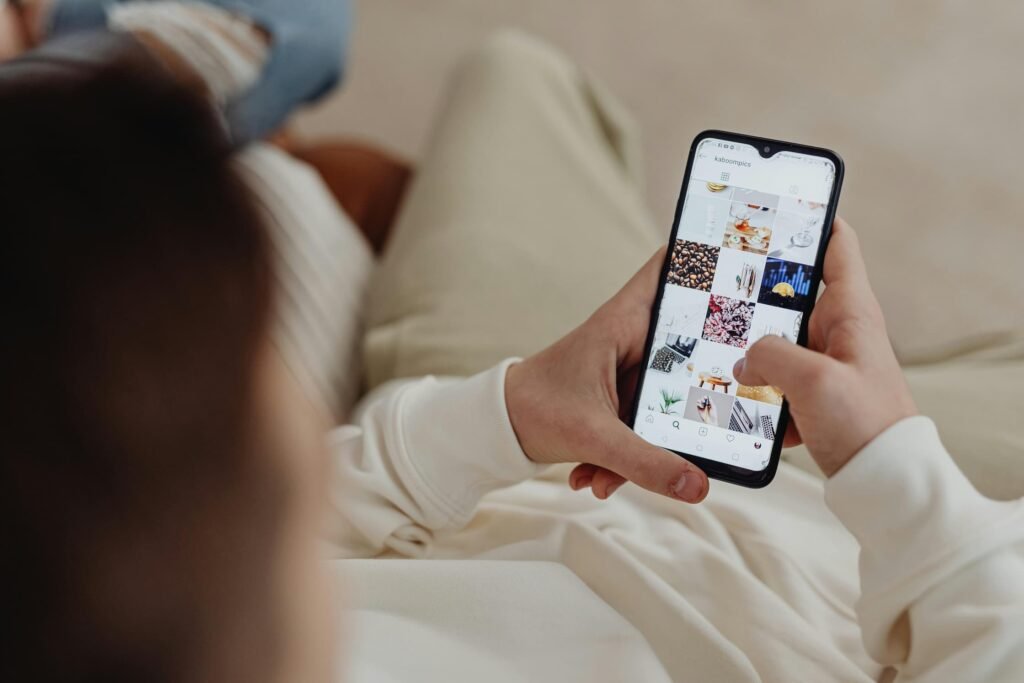 Woman scrolling Instagram feed on smartphone, illustrating how aesthetic patients browse social media before booking a med spa consultation