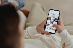 Woman scrolling Instagram feed on smartphone, illustrating how aesthetic patients browse social media before booking a med spa consultation