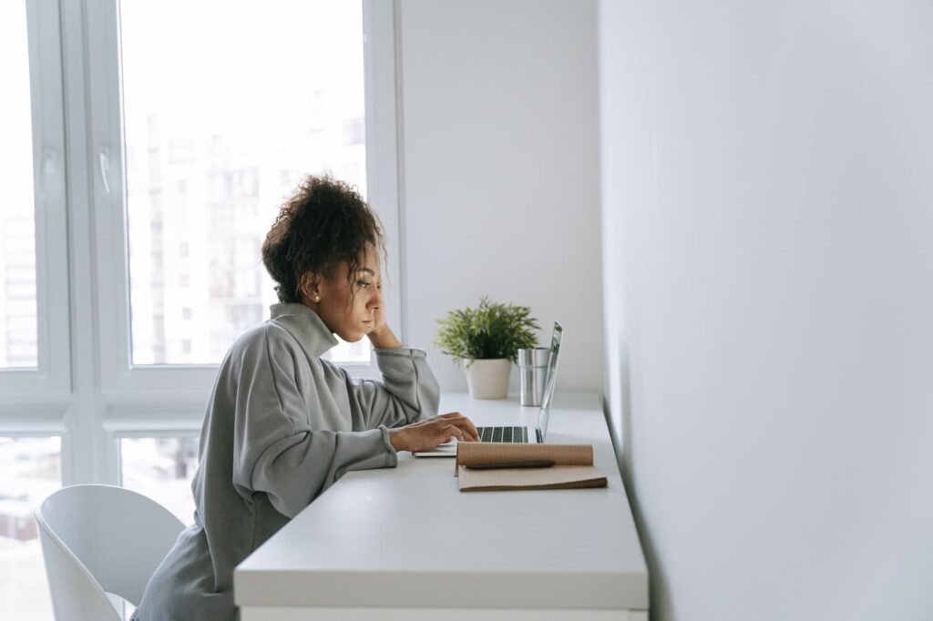 Med spa owner reviewing schema markup guide on laptop at clean minimal desk