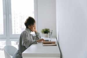 Med spa owner reviewing schema markup guide on laptop at clean minimal desk