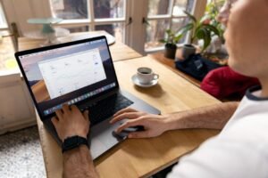 Person reviewing an analytics dashboard with performance charts on a laptop, illustrating how Traditional SEO vs AI SEO are measured with different metrics